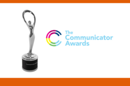 Logo for The Communicator Awards next to a silver statue trophy