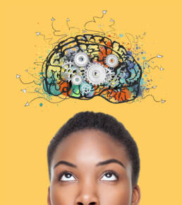Girl looks up towards a graphic of a creative brain