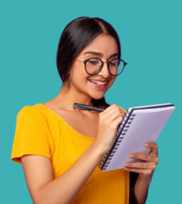 Woman smiling while writing on a notepad